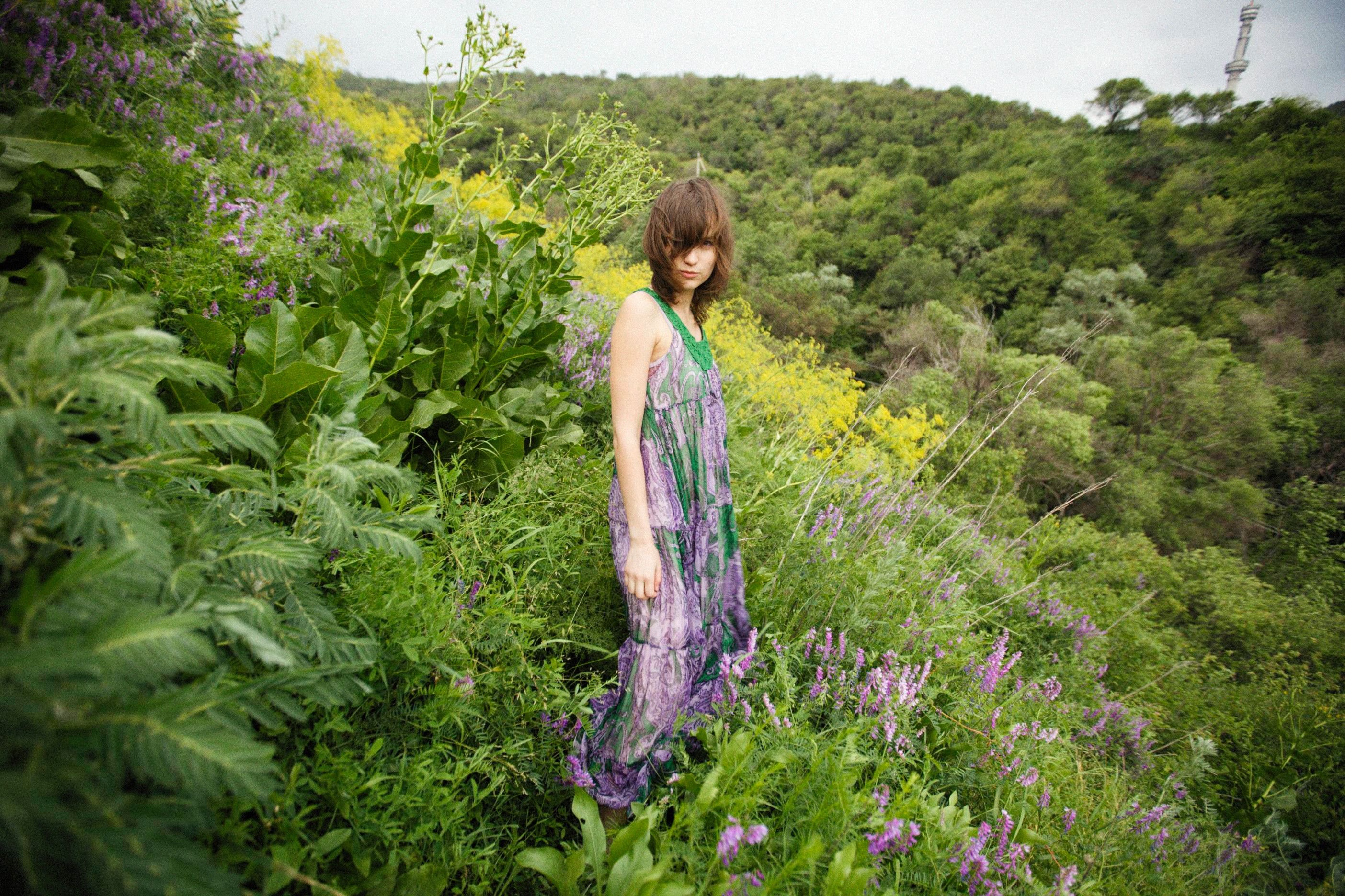 Woman in Dress Posing among Flowers, Bushes and Trees · Free Stock Photo