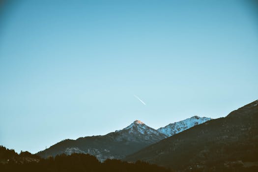 Beautiful view of snow-capped mountains under a clear blue sky in Innsbruck, Austria.