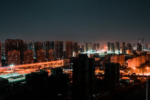 A stunning view of a city's skyline illuminated with vibrant lights at night, showcasing urban architecture.
