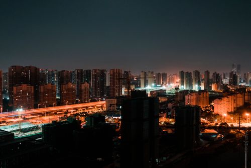 Free A stunning view of a city's skyline illuminated with vibrant lights at night, showcasing urban architecture. Stock Photo
