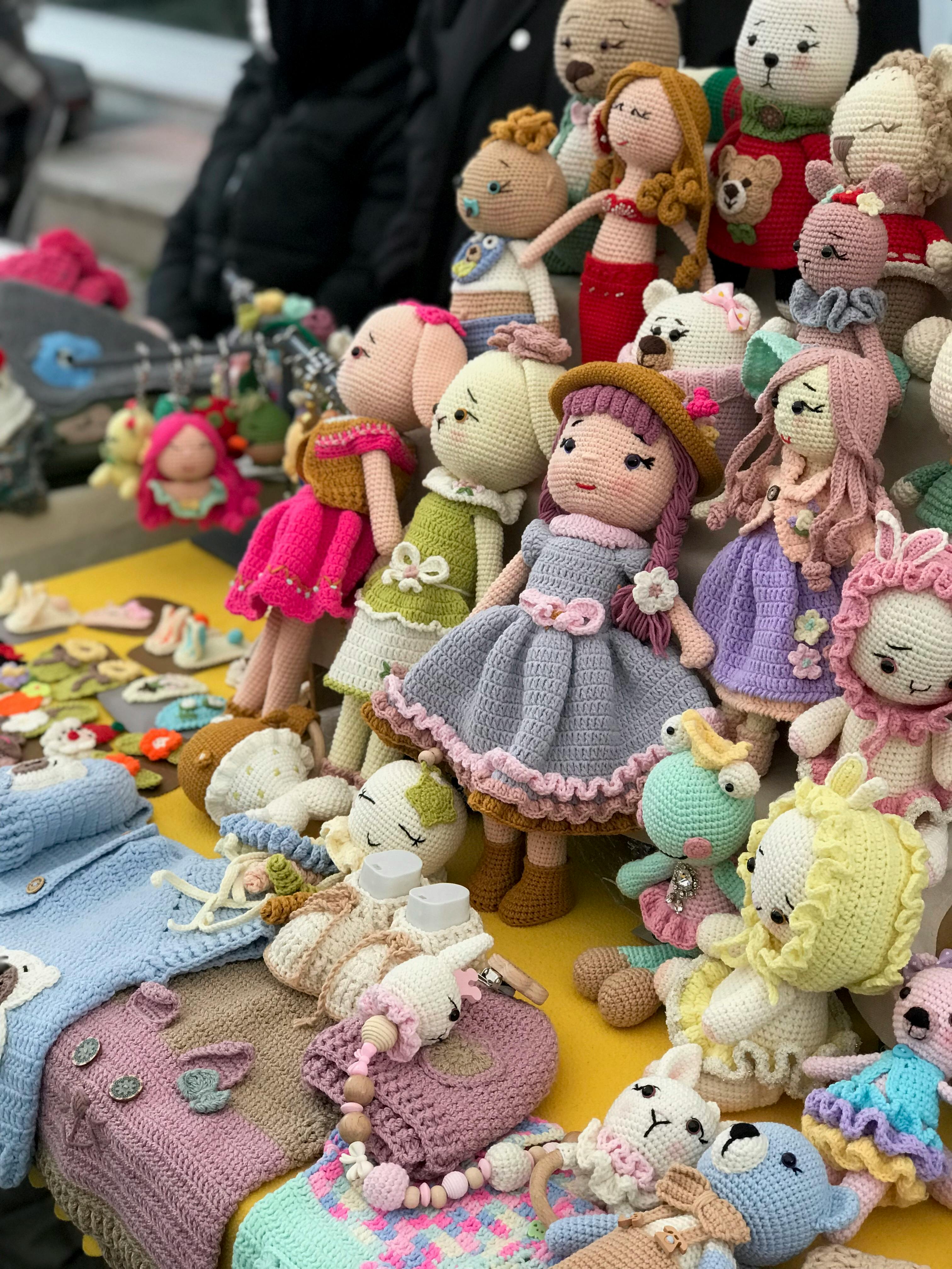 Close-up of colorful handmade crochet dolls displayed at Üsküdar market in İstanbul.