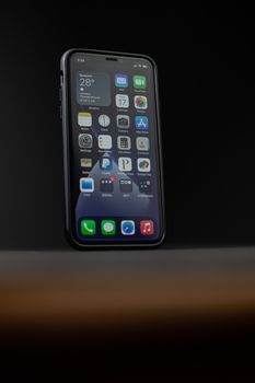 Close-up of a smartphone displaying apps including a weather app. Ideal for tech themes.
