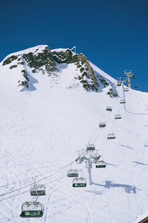 A Cable Cars Near the Snow Covered Mountain