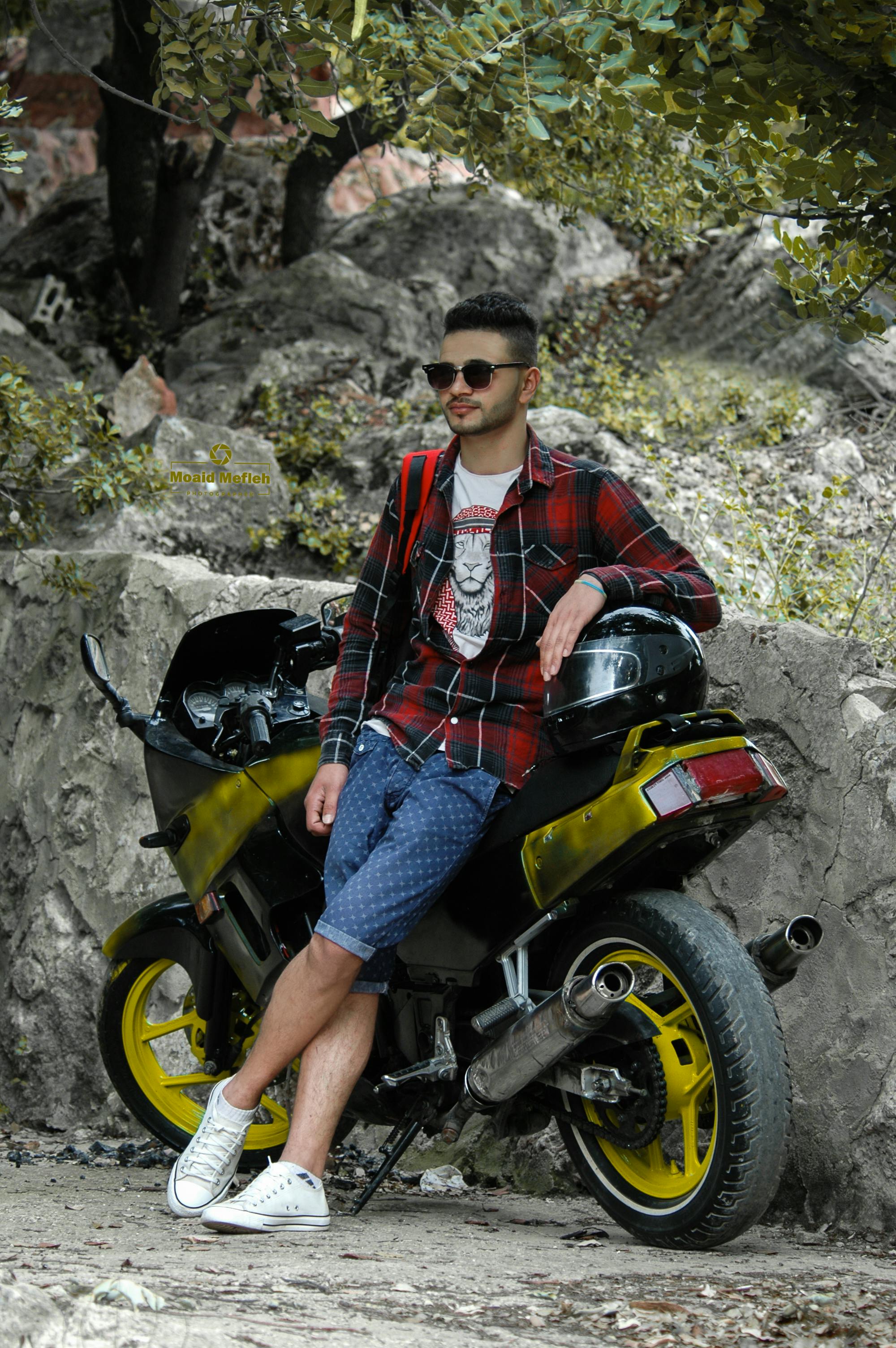 Travel, speed, freedom concept. Fashionable male motorcycle driver poses on  black motorbike, wears protective sunglasses, black jacket and shoes, rides  in beautiful yellow park during autumn time. 8836761 Stock Photo at Vecteezy