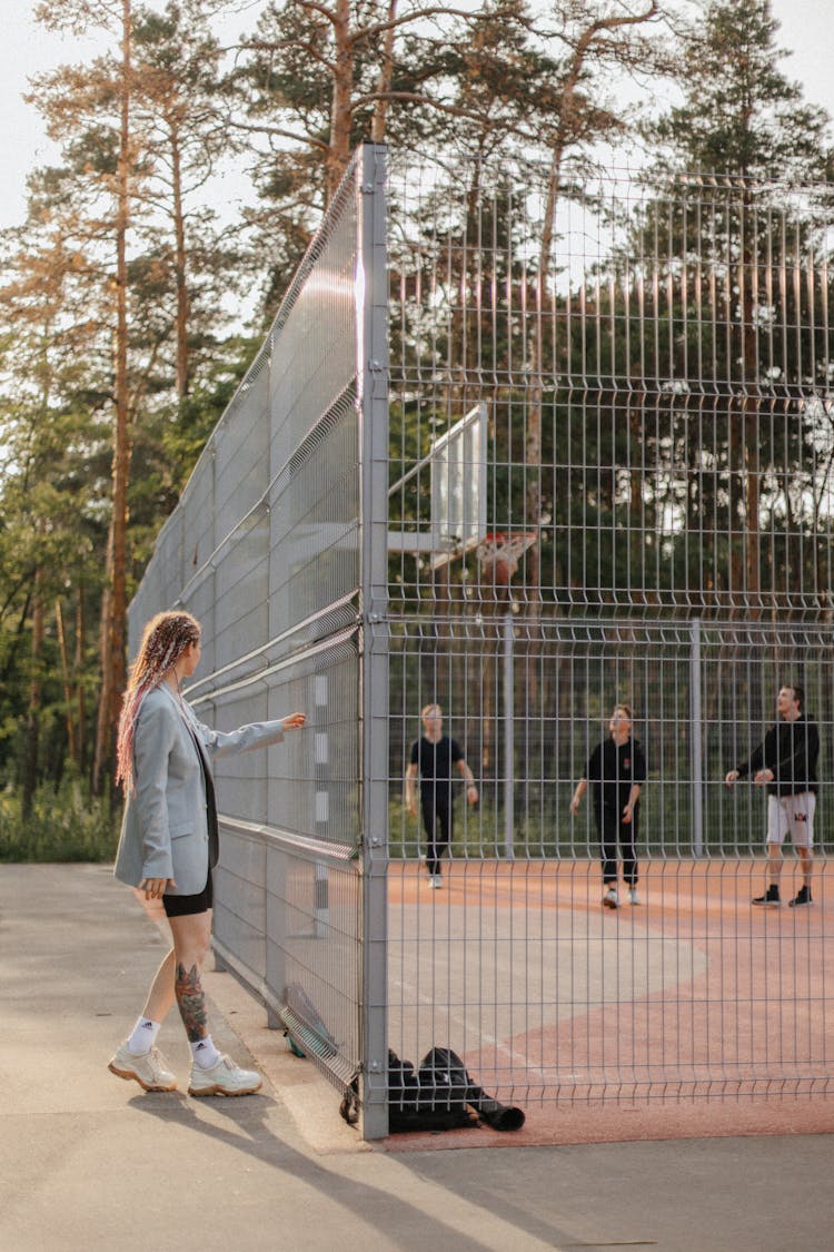 A Woman Watching Basketball Players