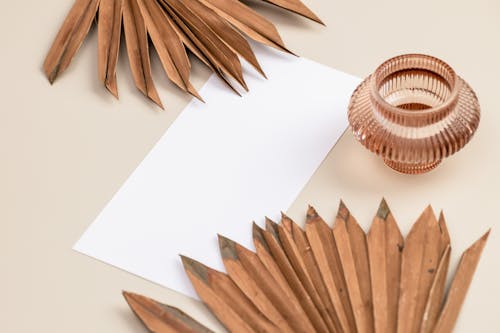 Brown Dried Leaves Beside the Blank White Paper