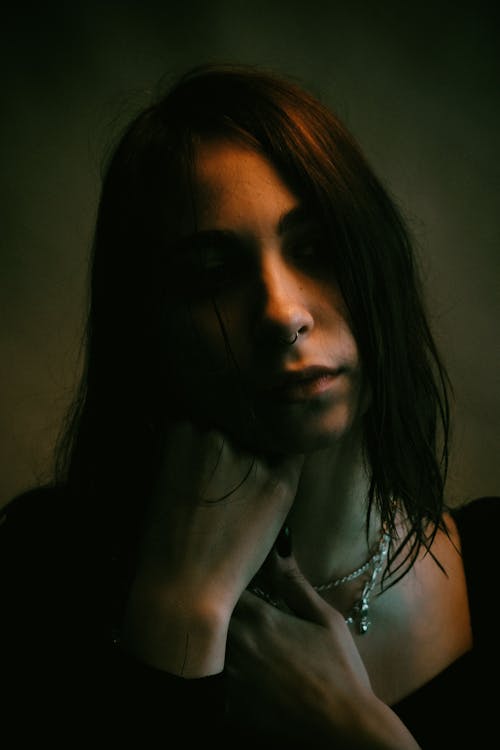 Woman in Black Top Wearing Silver Necklace