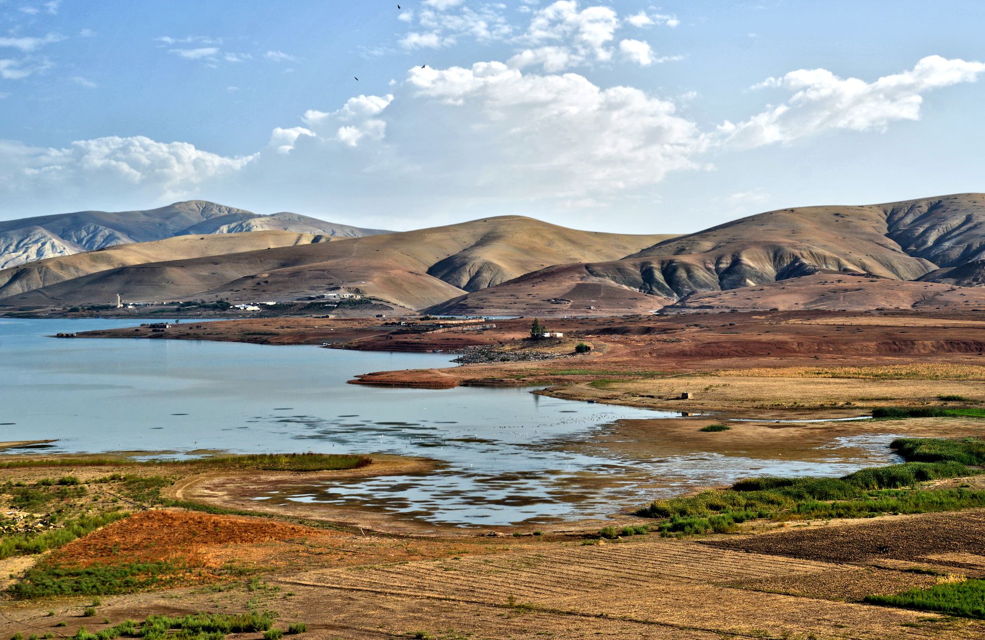 Wide view of a stunning Moroccan landscape highlighting hills and a tranquil lake.