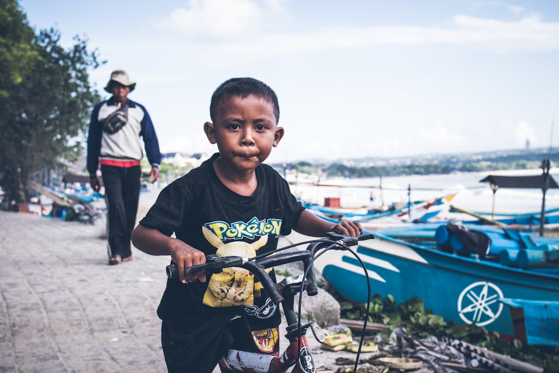 Free Boy Riding on Black Bicycle Stock Photo