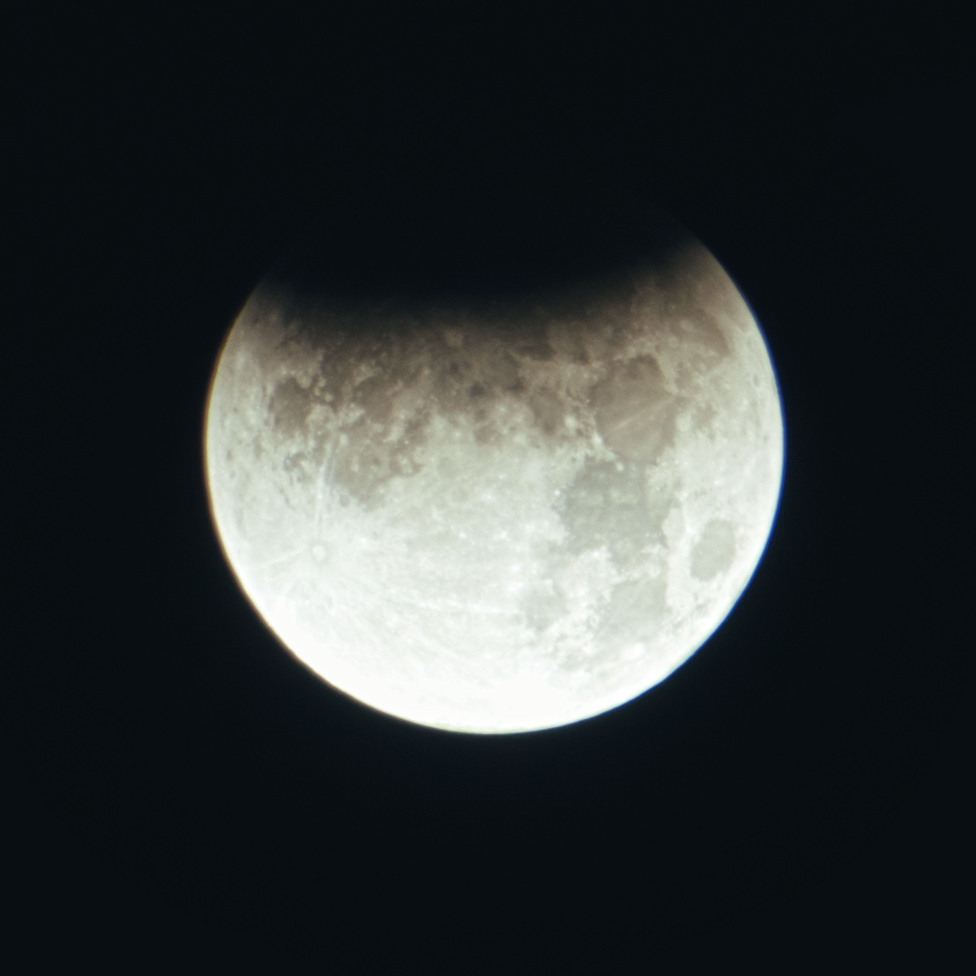 Captivating image of a partial lunar eclipse with shadow covering part of the full moon.