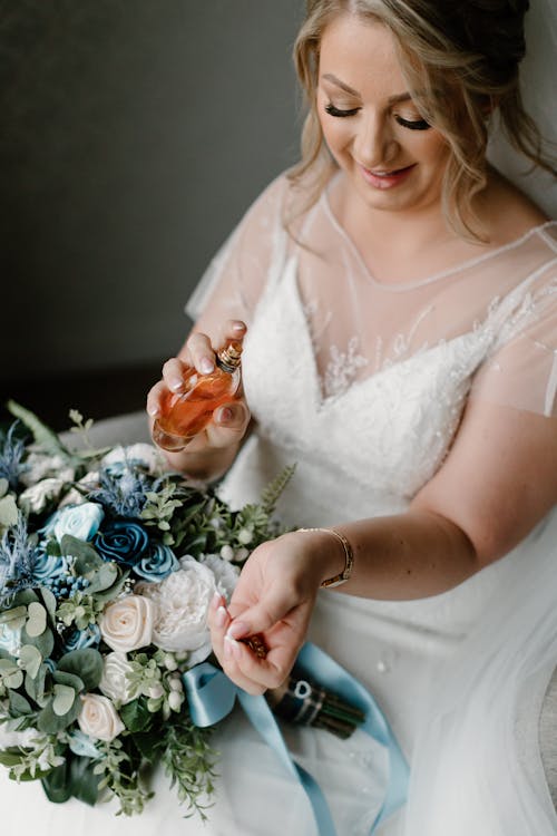 A Bride Spraying Perfume on Her Wrist