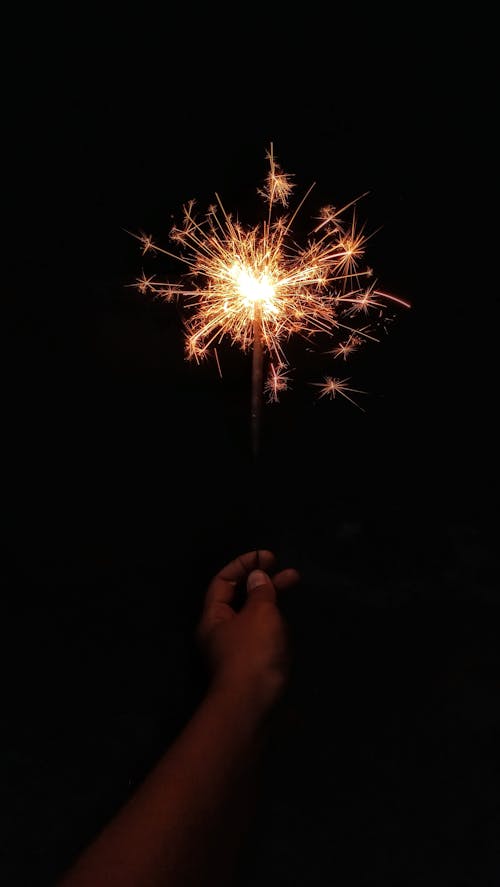 A Person Holding a Sparklers in the Dark