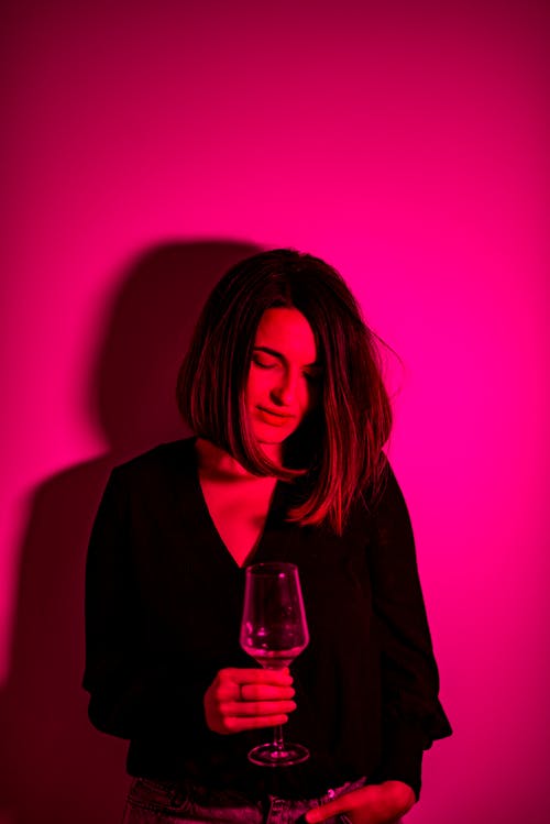 Free Woman in Black Long Sleeve Shirt Holding Clear Wine Glass Stock Photo