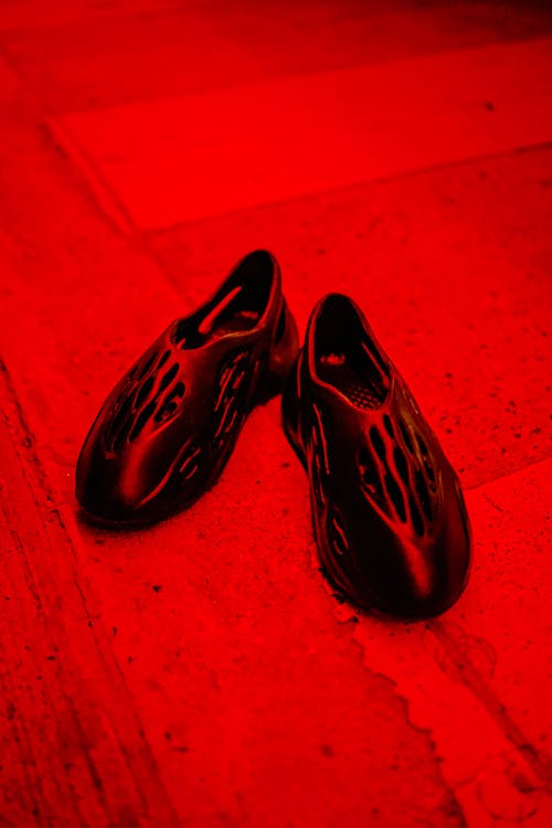 Footwear on Concrete Floor With Red Light