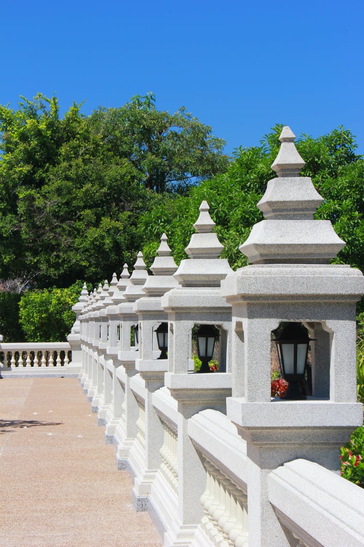 Concrete Lamp Posts On A Concrete Fence With Balusters