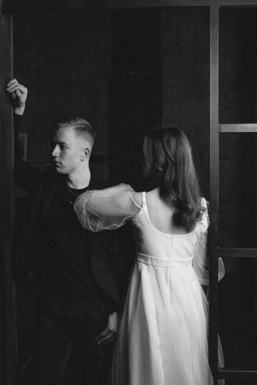 Free A captivating black and white portrait of an elegantly dressed couple indoors, exuding a classic and moody atmosphere. Stock Photo