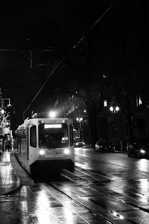A Grayscale Photo of a Tram on the Road