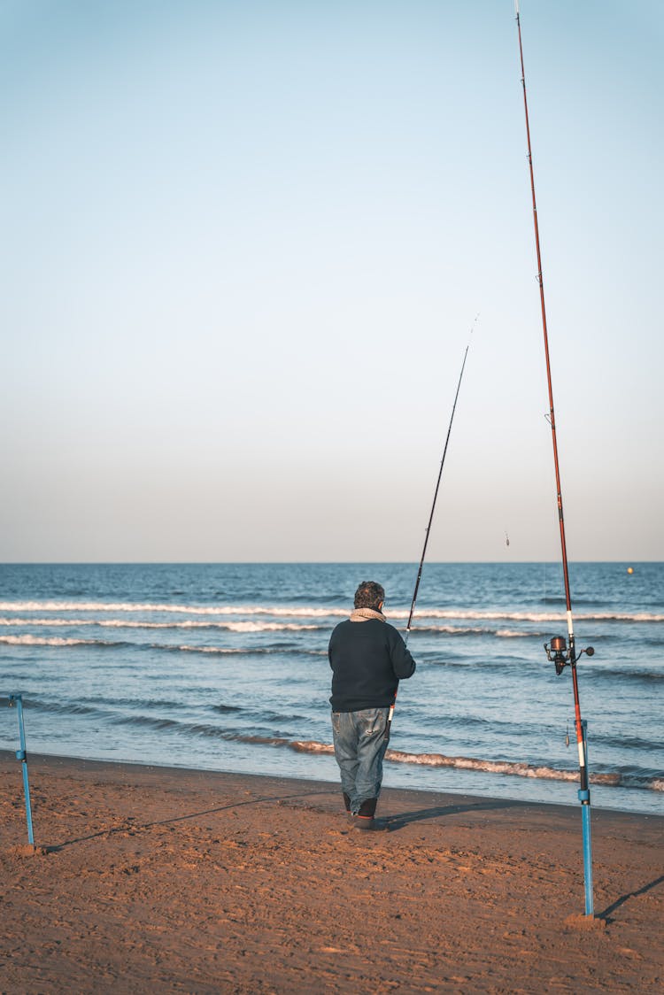 Man Fishing On A Beach 