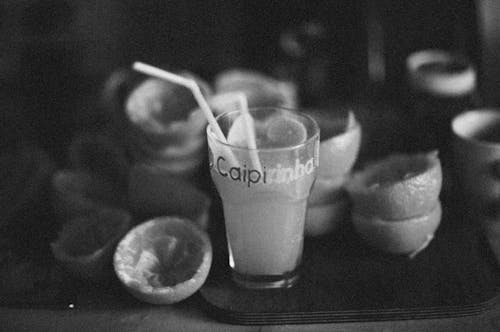 Free Grayscale Photo of Drinking Glass With Ice Cubes and Straw Stock Photo