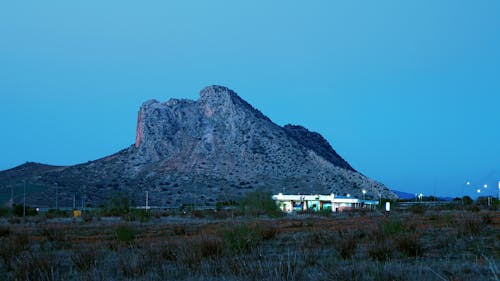 Building with Lights in Mountain Landscape