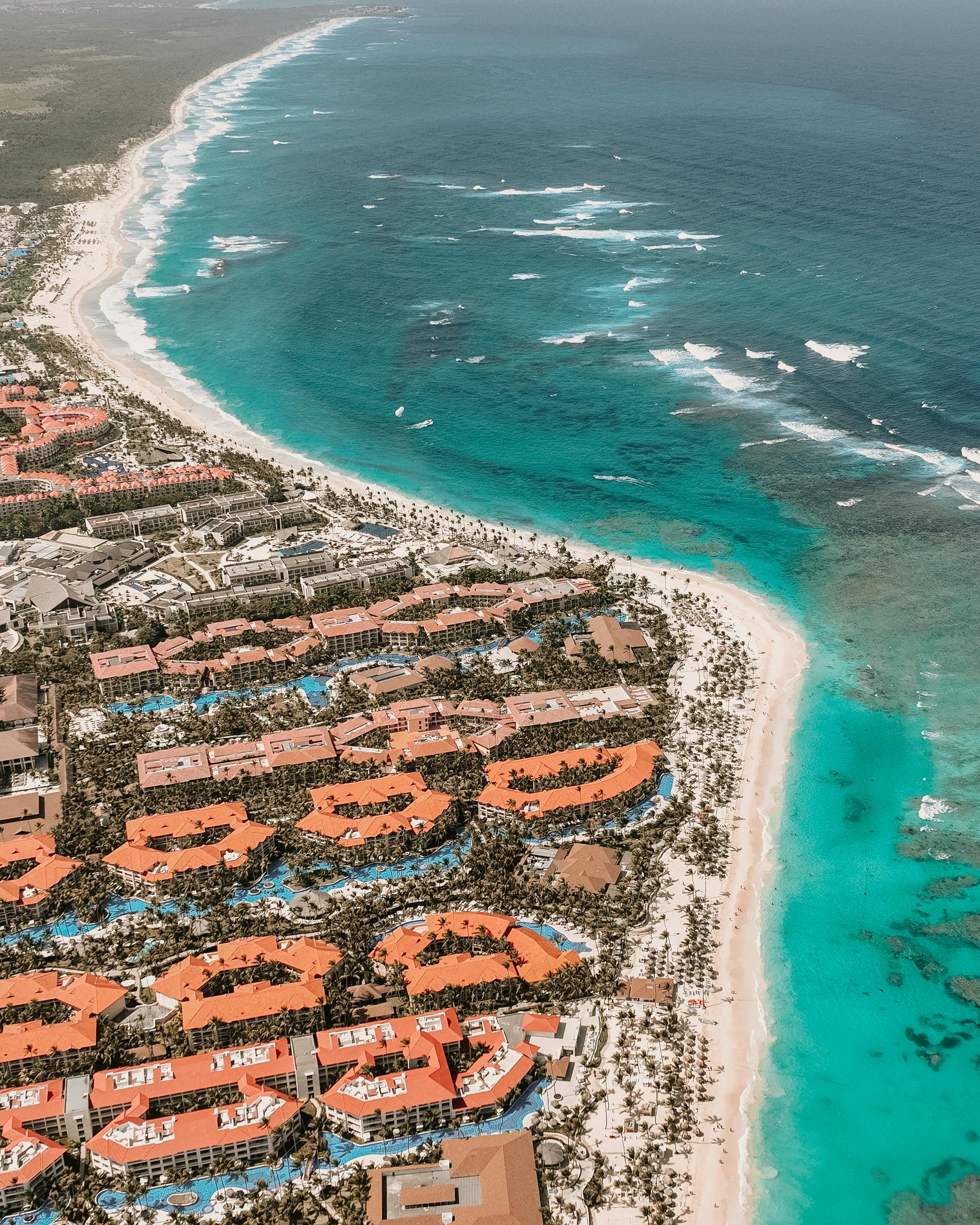 Prescription Goggle Inserts - Stunning aerial view of a resort by turquoise ocean waves and pristine sandy beach.