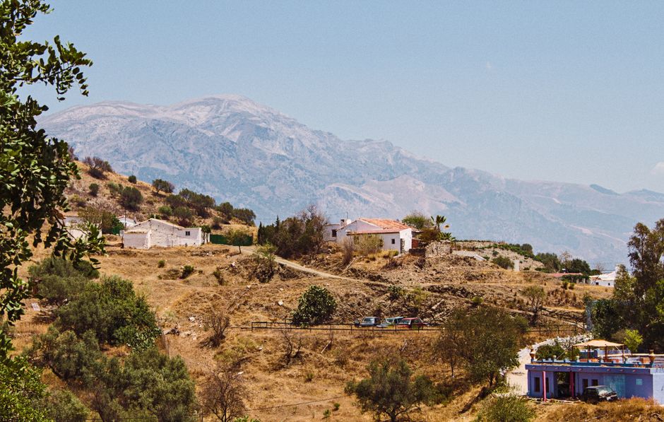 Charming rural scene in Cordoba, Spain, with white houses and mountains.