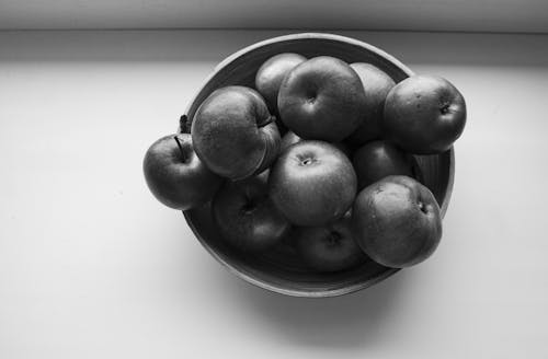 Grayscale Photo of Apples in the Bowl