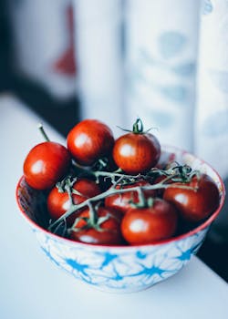 Vibrant cherry tomatoes in a stylish bowl, perfect for healthy meals.