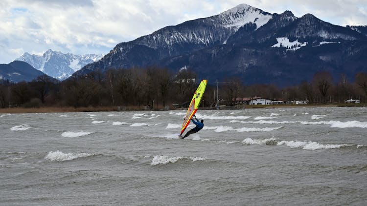 Man Windsurfing In Sea