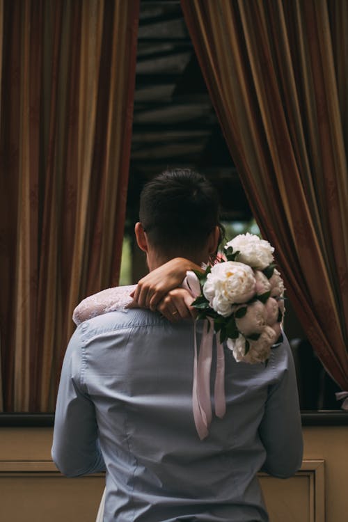 Back View of Bride Hugging the Groom 