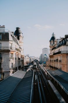 High angle view of a modern railway station with city architecture and tracks.