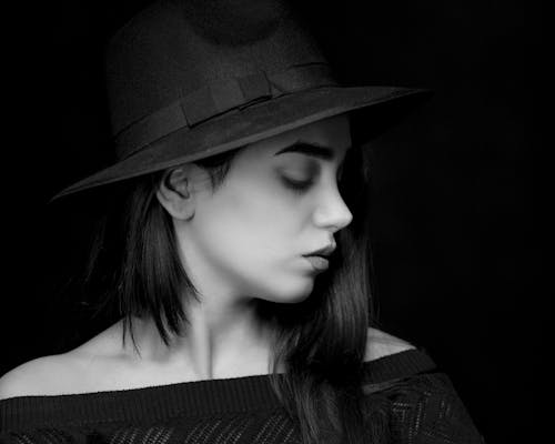 Free A Woman Wearing Fedora Hat and Black Shirt Stock Photo
