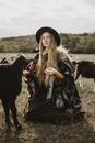 Woman in Hat among Goats