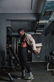 African American man getting ready for a workout in a modern indoor gym setting.