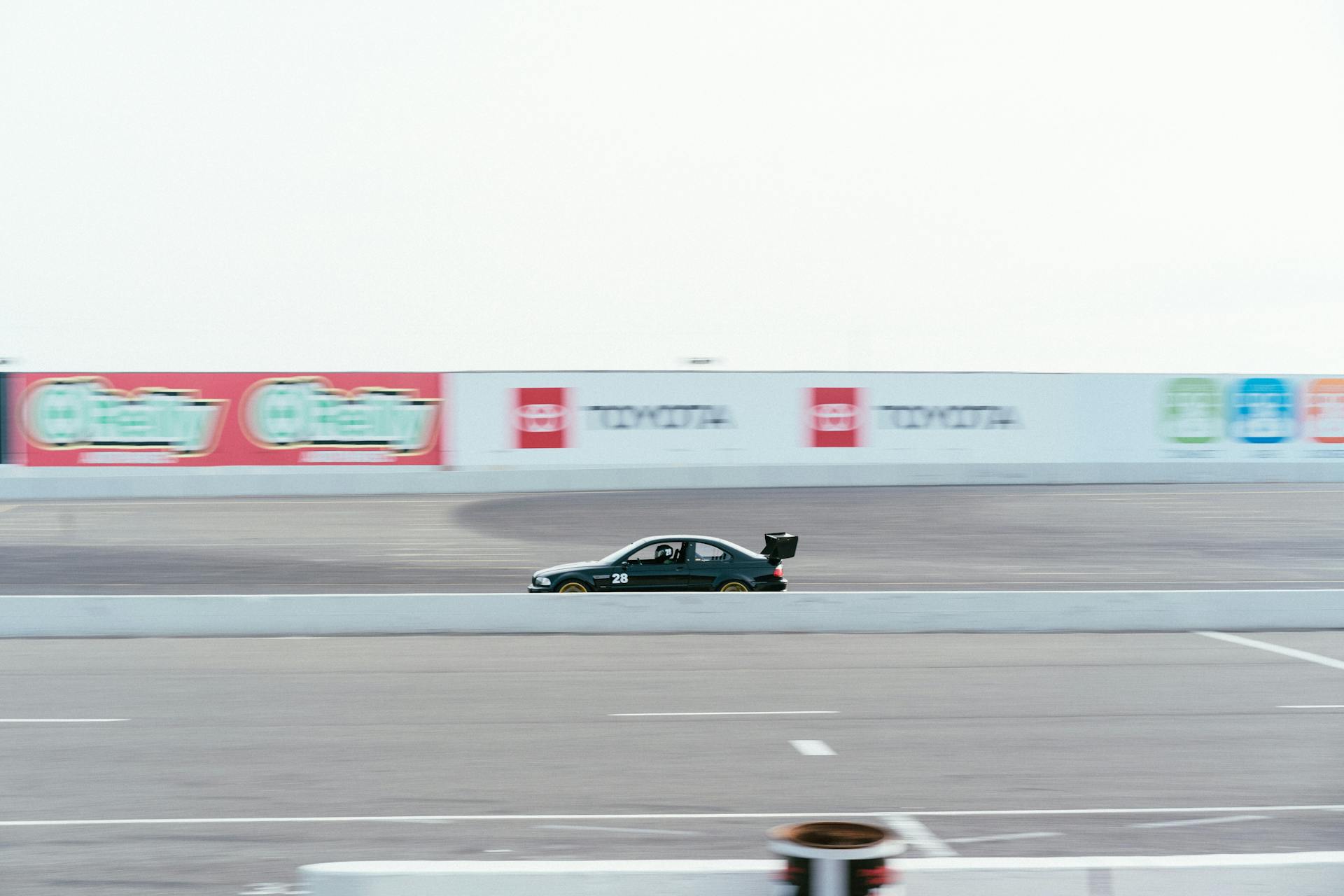 A sleek race car speeds down the Sonoma Raceway, capturing the thrill of motor sports.