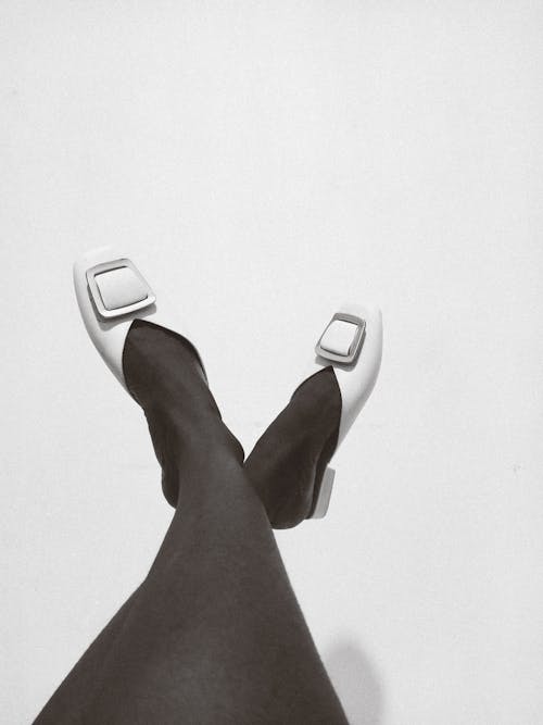 Black and White Photo of a Person Wearing Shoes