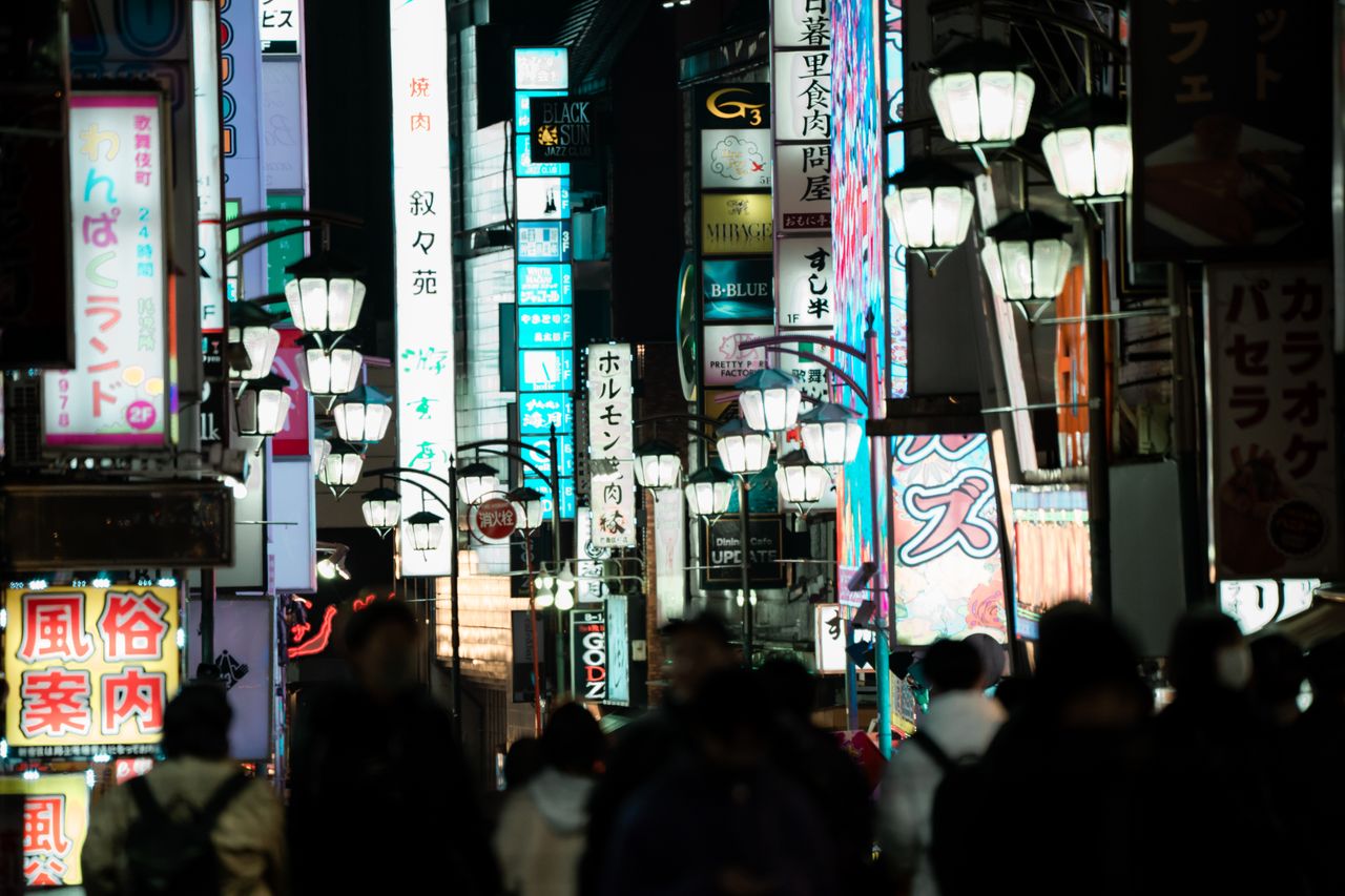 bustling street scene in shinjuku tokyo capturing vibrant signs and ev