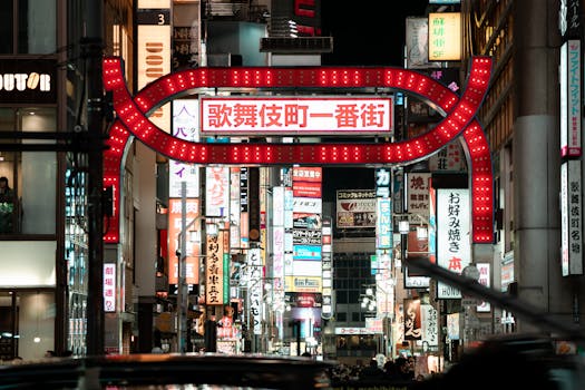 Explore the lively and illuminated streets of Kabukicho in Shinjuku, Tokyo, capturing the essence of urban nightlife.