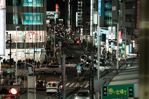 Vibrant nightlife and traffic in Shinjuku, Tokyo, showcasing urban energy and city life.