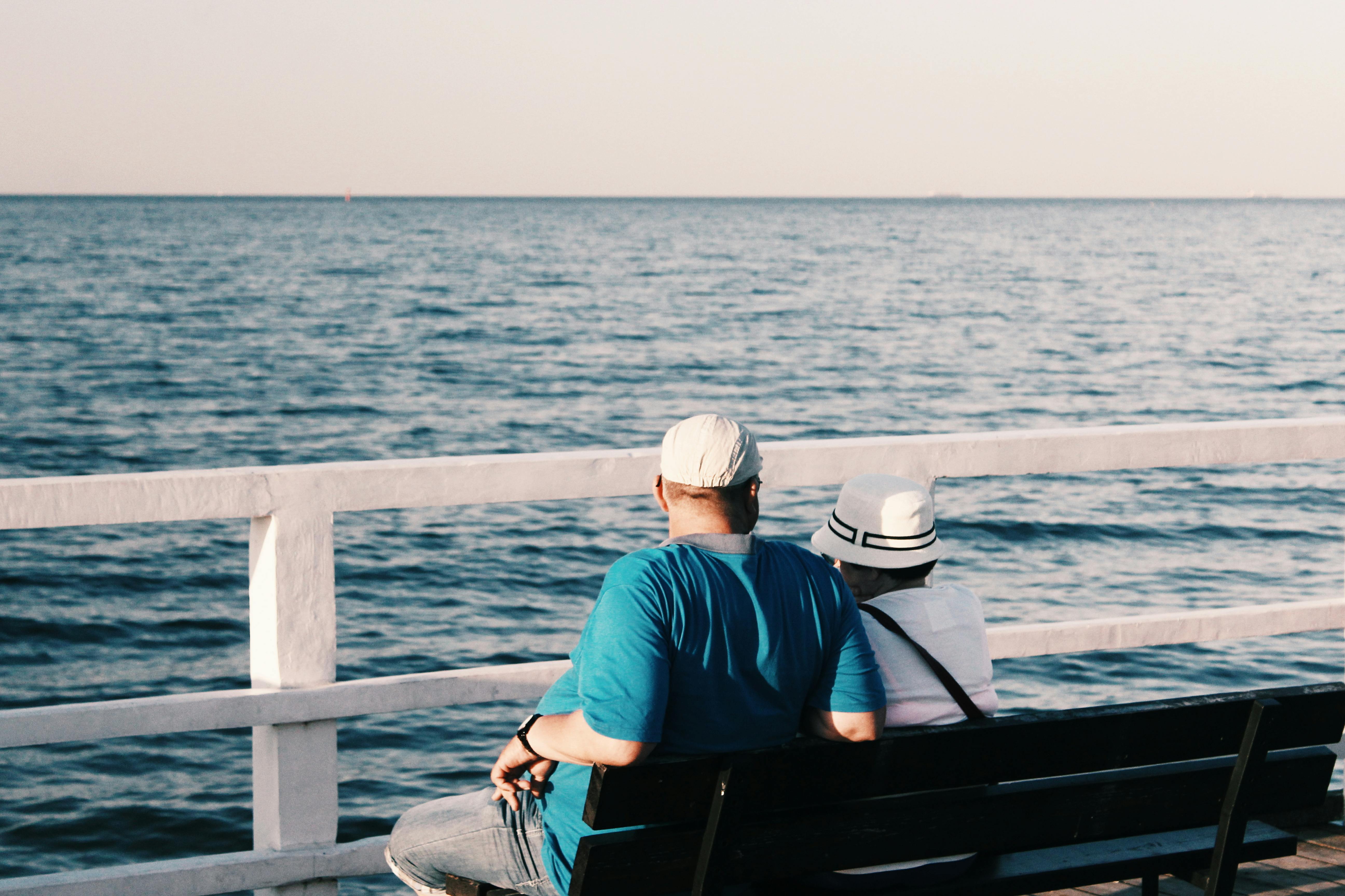 Four People On Lounge Chairs Near The Beach · Free Stock Photo