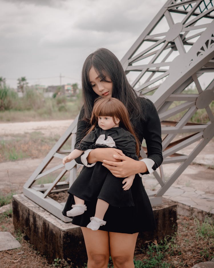 A Woman Carrying Her Doll