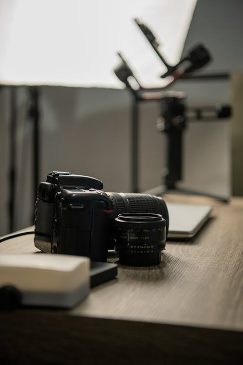 Photo of a Camera on a Wooden Table · Free Stock Photo