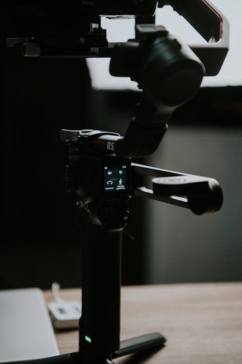 Black Tripod Holding a Camera