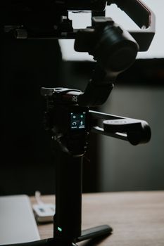 Detailed shot of professional camera gimbal indoors, highlighting technology and equipment.