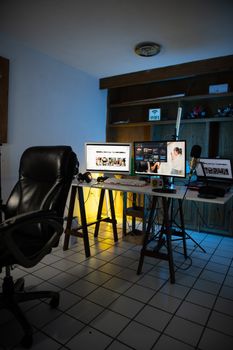 Contemporary home office setup with dual monitors, keyboard, and microphone on stylish table.