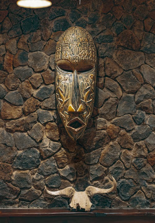 Wooden African Carving on Stone Wall