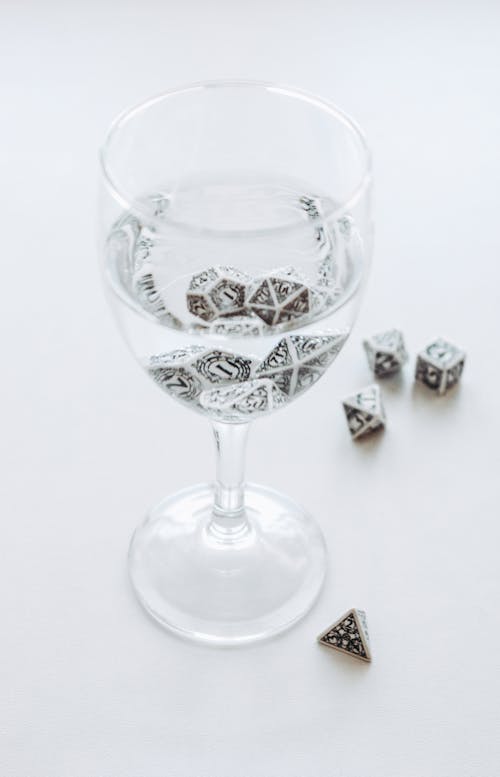 Glass of Water with Cubes on Table