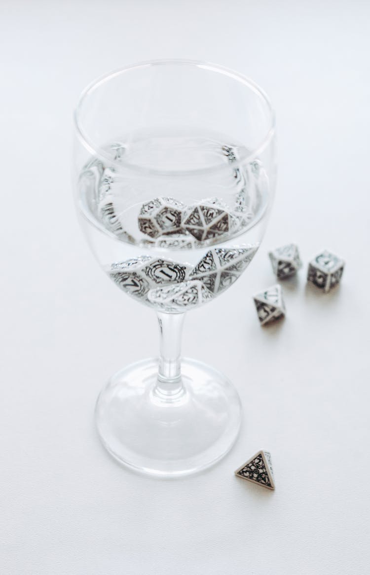 Glass Of Water With Cubes On Table