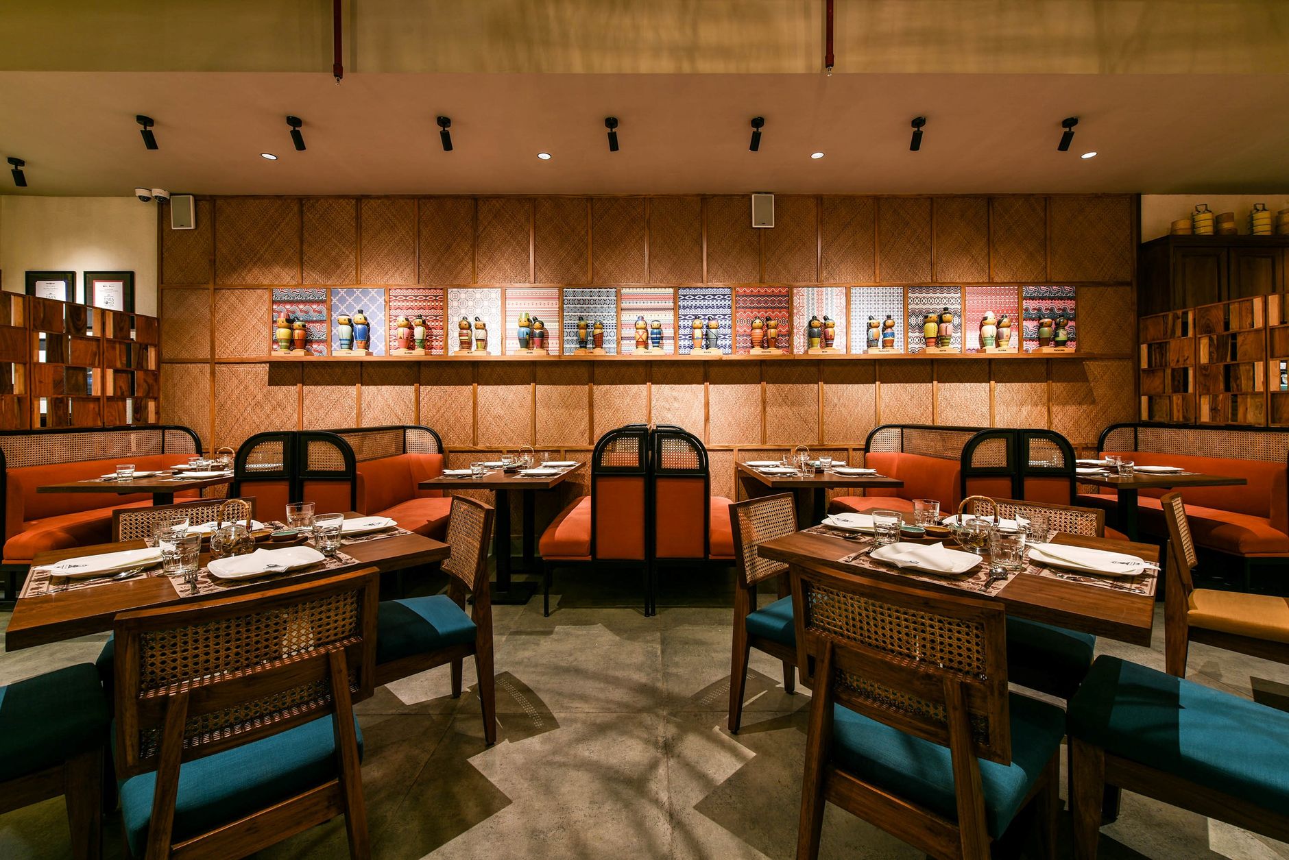 Warm and stylish restaurant setting with coordinated decor and prepared tables.