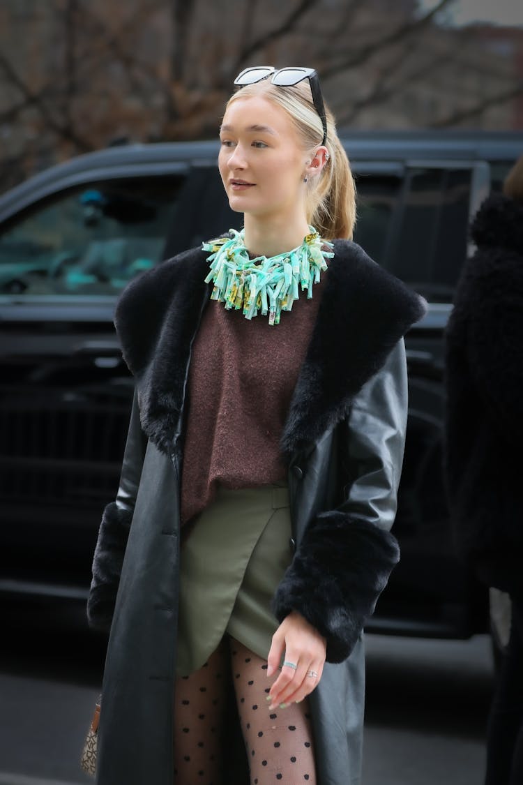 Blonde Woman In Black Leather Coat With Fur 